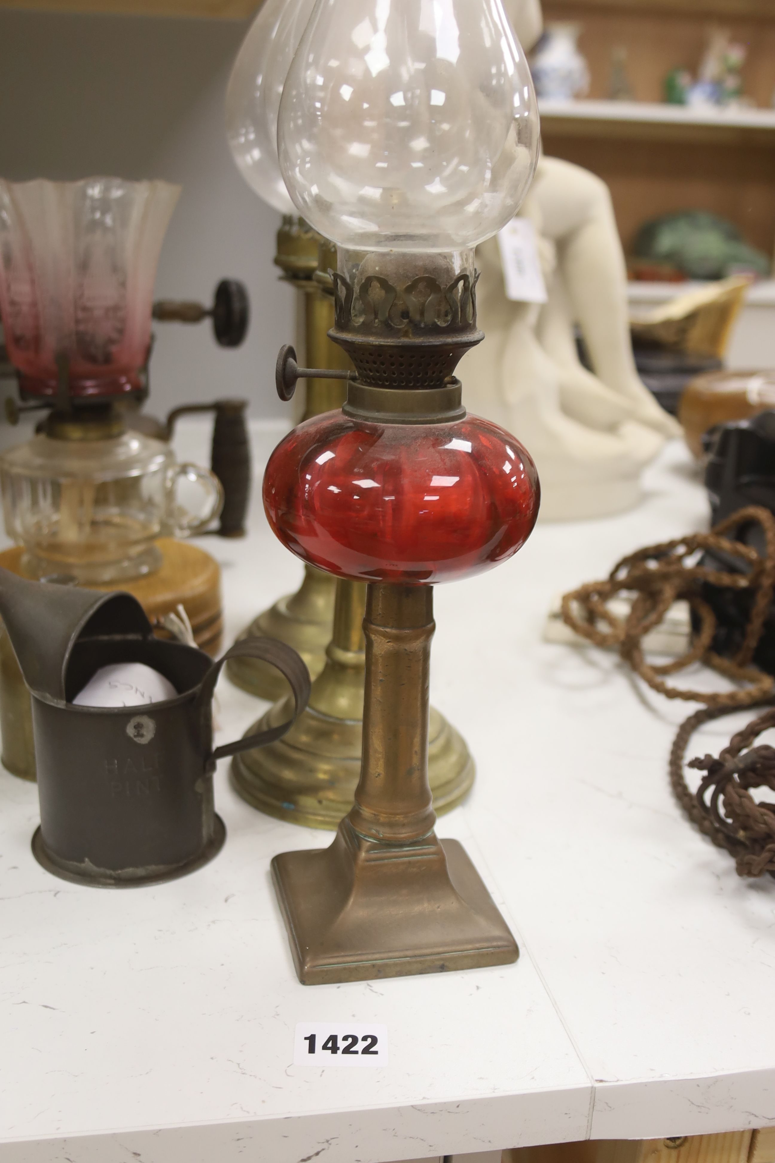 A pair of candle storm lamps, two oil lamps, a paint stripper, a jeweller's blow lamp and oil can, tallest 49cm